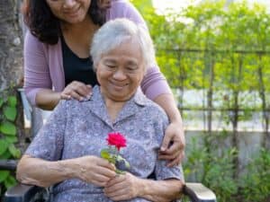 helping elderly woman with dementia care